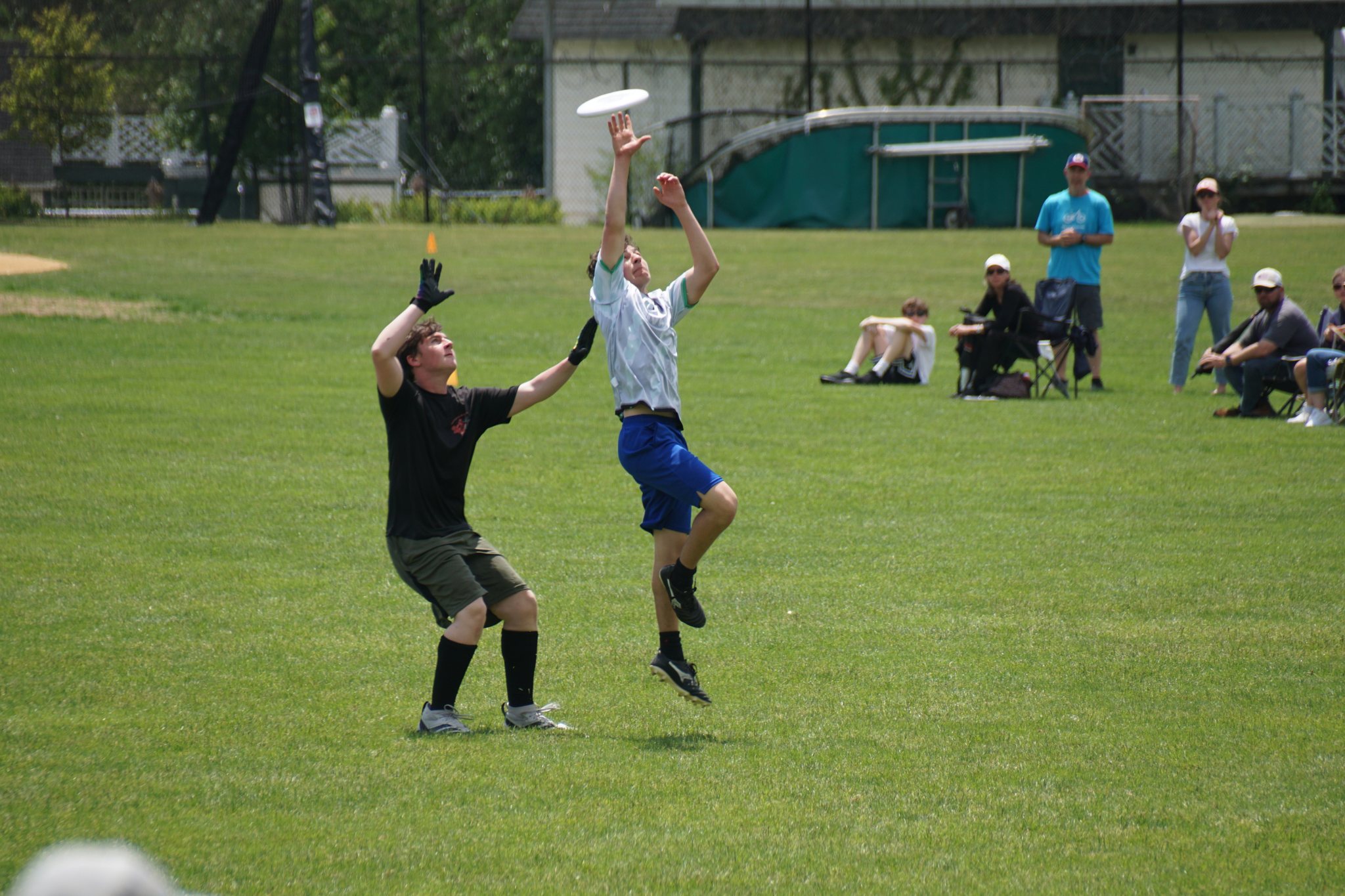 Two players leaping for the disc in a Walter Johnson Pitchers game